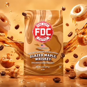 A bag of FDC Fire Department Coffee Glazed Maple Whiskey on a white background, with a black banner at the bottom reading 'SPIRIT INFUSED COFFEE | SEPTEMBER 2026'. The bag features a brown and beige swirl pattern with a red FDC logo.