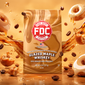 A bag of FDC Fire Department Affiliated Coffee Glazed Maple Whiskey stands upright in a stylized studio scene. The package is metallic gold with a red-and-white FDC logo and white product text.