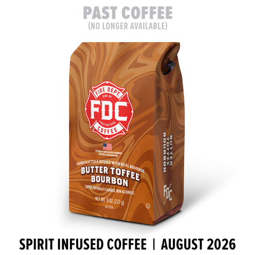 A bag of FDC Fire Department Coffee Butter Toffee Bourbon coffee stands on a white background. The packaging has a brown and tan wood-grain pattern with a red and white FDC logo.