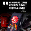 A bag of Backdraft Fire Department Coffee (FDC) is shown prominently in the foreground, with a red coffee mug shaped like a fire hydrant and scattered coffee beans on a dark background. Large promotional text at the top reads, 'AN AMAZING COFFEE WITH RICH FLAVOR AND BOLD AROMA' attributed to Zach C.