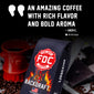 A bag of Backdraft Fire Department Coffee (FDC) is shown prominently in the foreground, with a red coffee mug shaped like a fire hydrant and scattered coffee beans on a dark background. Large promotional text at the top reads, ’AN AMAZING COFFEE WITH RICH FLAVOR AND BOLD AROMA’ attributed to Zach C.