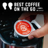 A hand inserts a single FDC Coffee Medium Roast single-serve pod into a coffee maker. The pod has a red and white label with the FDC logo.