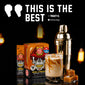 FCD Coffee Company Skull-Caramel Instant Coffee packaging shown alongside a prepared caramel latte in a glass, a metal cocktail shaker, and caramel cubes on a black background with warm blurred lights. Large text at the top reads “THIS IS THE BEST” with a verified buyer badge.