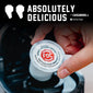 A hand holds a single FDC Vanilla Bean Powder coffee pod over a black coffee maker, with large text reading ’ABSOLUTELY DELICIOUS’ and a verified buyer badge at the top.