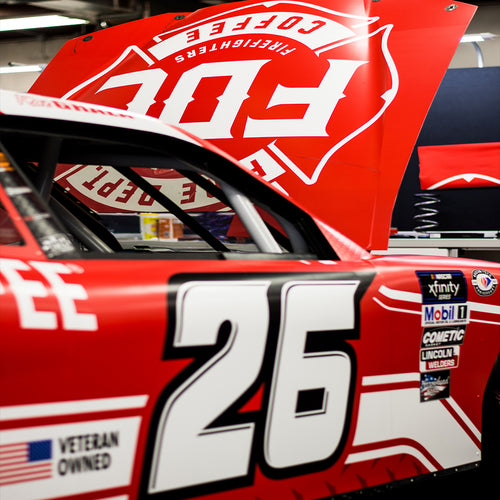 NASCAR car number 26 with hood open and fire Department Coffee logo
