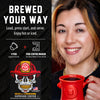 A promotional graphic for a coffee pod maker showing a smiling woman on the right holding a red coffee mug, and product text on the left. The text reads 'BREWED YOUR WAY' and includes a skull illustration wearing a firefighter helmet with the brand FOC visible on the pod packaging graphic.