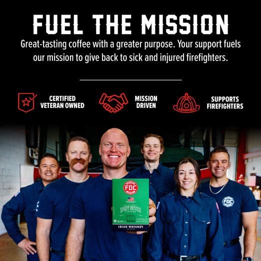 A group of smiling firefighters in navy uniforms stand in a garage-like setting while holding a green box of PFC Smokeless Irish Whiskey. Above them, bold white text reads ’FUEL THE MISSION’ with supporting callouts: ’Certified Veteran Owned,’ ’Mission Driven,’ and ’Supports Firefighters.