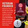 A hand holds a box of FOC Coffee Black Cherry Bourbon capsules against a red promotional background with text about a veteran founder and a small circular photo inset.