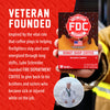 A hand holds a box of FDC Donut Shop Coffee against a red promotional background with white text about a veteran-founded coffee brand. The box is dark brown with a red circular FDC logo and an orange donut graphic.