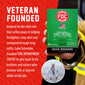 A hand holds a green and black box of FOC Fire Department Irish Whiskey coffee against a red promotional background with white text about veteran funding for firefighters. A small circular photo of a man in a sailor uniform appears at the bottom.
