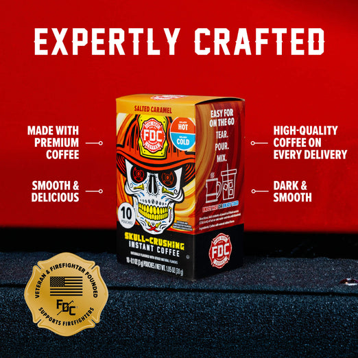 An FDC Salted Caramel Instant Coffee box shown on a dark textured surface against a bright red background, with marketing text around it reading ’EXPERTLY CRAFTED’ and feature callouts.