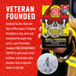 A hand holds a box of Fire Department Coffee ’Skull-Crushing’ Instant Espresso Coffee against a red textured background with white text. The box features a yellow and black design with a skull wearing a firefighter helmet.