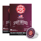 A box of FDC Spirit Infused Coffee in Black Cherry Bourbon roast, shown with two additional boxes behind it and a single coffee capsule in front on a white background.