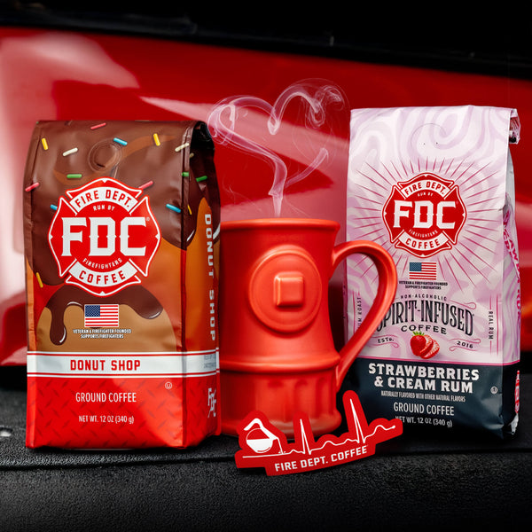 The Coffee Lovers Valentine's Day Bundle, containing a bag of Donut Shop Coffee, a bag of Strawberries and Cream Rum Infused Coffee, a red EKG Sticker, and a red Fire Hydrant mug.