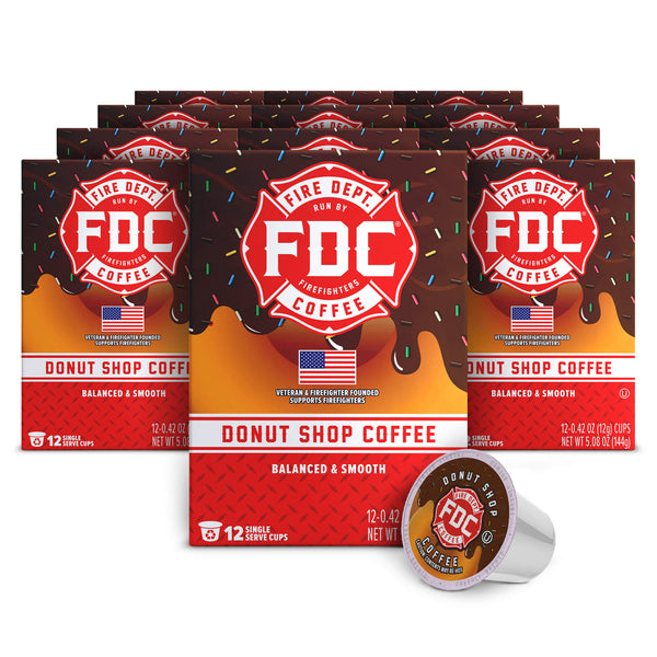Multiple boxes of FDC Donut Shop Coffee with a single cup on a white background