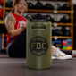 Lifestyle photo featuring a 64oz military green stainless steel Fire Department Coffee Growler with Fire Department Coffee logo facing forward.