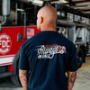 Lifestyle image of someone wearing an Always on Call T Shirt. The back of the shirt has an image of a fire engine and text that reads, Fire Dept. Coffee Always on Call