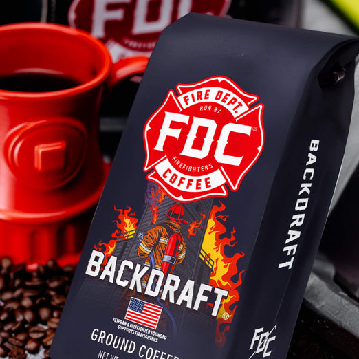 Fire Department Coffee ’Backdraft’ package with a red cup and coffee beans in the background