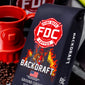 Fire Department Coffee ’Backdraft’ package with a red cup and coffee beans in the background