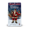 A 12 ounce bag of Fire Department Coffee Christmas Blend featuring an illustration of Santa holding a fire hydrant coffee mug and a bag full of firefighter tools