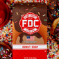 A 12-ounce package of Fire Department Coffee’s Donut Shop Coffee surrounded by rainbow sprinkles and donuts.