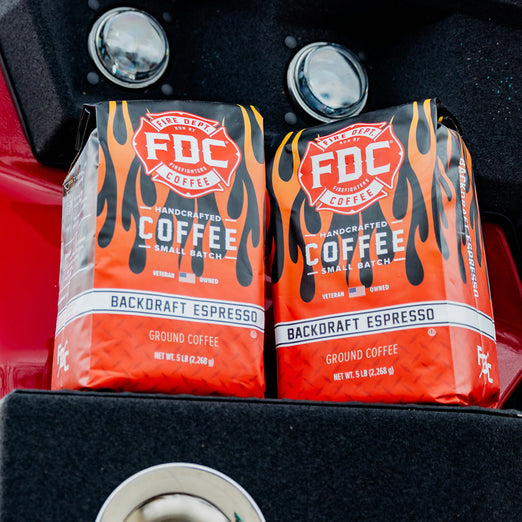 Two 5lb bags of Backdraft Espresso sitting on a fire truck.