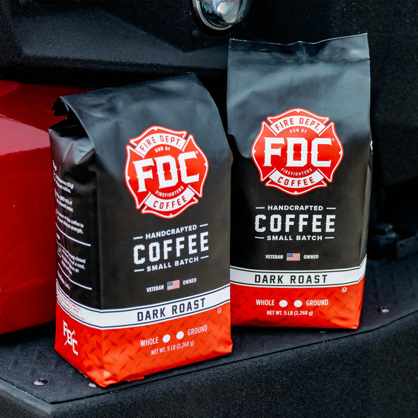 A bag of Dark Roast Coffee next to a glass of coffee