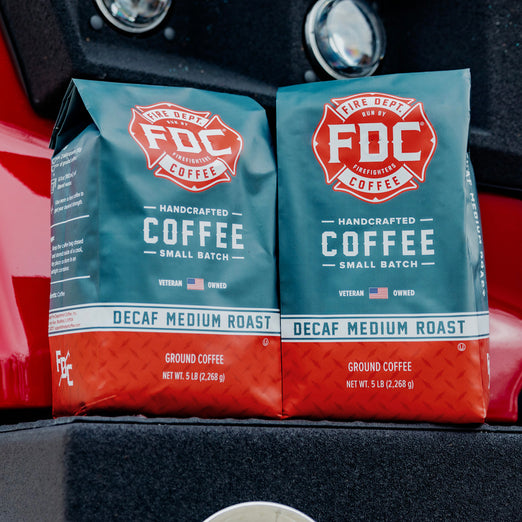 Two 5lb bags of Decaf Coffee sitting on a fire truck.