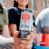 A close up photo of someone holding a can of Nitro Vanilla Bean Bourbon Coffee.