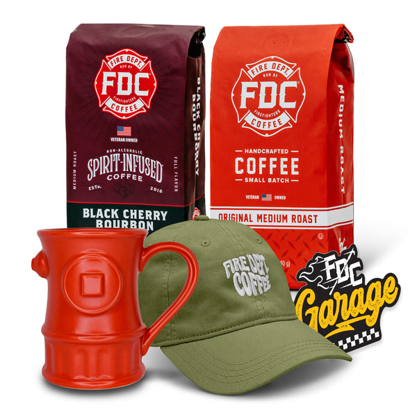 A bag of Black Cherry Bourbon coffee and medium roast coffee with a red fire hydrant mug, green dad hat and sticker in front on a white background.