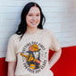 A lifestyle image of someone wearing the Female Firefighter Shirt. The front of the shirt features imagery of a female firefighter with text that reads, ”Putting out fires for over 200 years”.