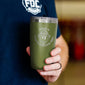 A man holding the green tumbler with the Have A Caffeinated Day design on the front of the tumbler.
