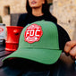 A lifestyle image of the FDC Green with the FDC maltese cross logo on the front