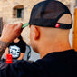A lifestyle image of someone wearing the FDC Green Hat