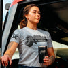 A lifestyle image of someone wearing the Jobtown Shirt. This grey shirt features "Jobtown" on the front in a script font and text underneath that reads, "Fire Dept. Coffee"