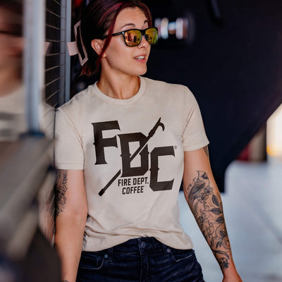 Five Fire Dept. Coffee T-shirts in red, vintage white, military green, heather gray, and black, each featuring a large FDC logo with a pike pole graphic running through it and small 'Fire Dept. Coffee' text below