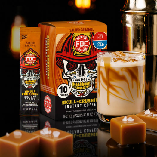 FDC Skull-Crushing Instant Coffee packages with a salted caramel latte and caramel candies on a dark background.
