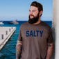 An image of someone wearing the Salty Shirt. The front of the shirt says, ”Salty” across the chest.