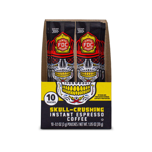 A front facing, opened box of Fire Department Coffee, Skull-Crushing Instant Espresso Coffee, showing 10 individual pouches with skull-themed packaging and a yellow and black design.