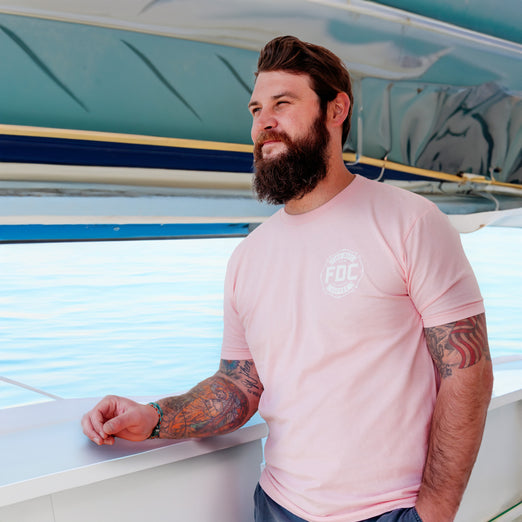 A lifestyle image of someone wearing the Stay Back Shirt in Pink. 