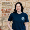 A lifestyle image of someone wearing the Stay Back Shirt in Navy. The front of the shirt features the FDC maltese cross in white on the chest.