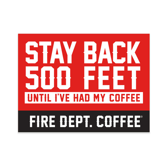 A red sticker with white text that reads STAY BACK 500 FEET UNTIL I’VE HAD MY COFFEE