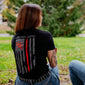 A lifestyle image of someone wearing the Thin Red Line Shirt. The back of the shirt features the thin red line flag with the FDC pike pole logo and text that reads ”Fire Dept. Coffee”