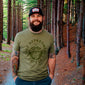 A lifestyle image of the Wildland Firefighter Skull Shirt. The front of the shirt features a skull design with wildland firefighter inspiration. The text around the skull reads, ”Fire Department Coffee”