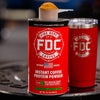 A can of Fire Dept. Coffee's Instant Coffee Protein Powder next to a Red FDC Tumbler.