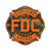 The Fire Department Coffee maltese cross logo with a camo background and orange outline