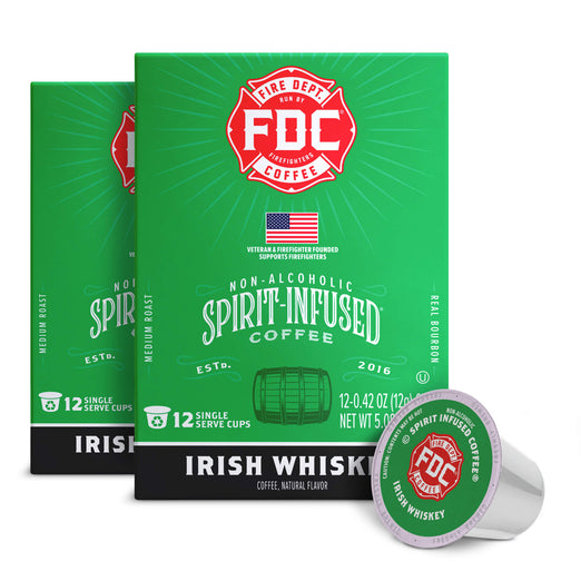 A box of FDC Fire Department New York City Coffee Irish Whiskey non-alcoholic spirit-infused coffee, shown with two additional boxes and a single single-serve coffee pod in the foreground on a white background.