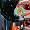 Someone placing an Irish Whiskey Infused Coffee Pod into a brewing machine