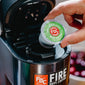 Someone placing an Irish Whiskey Infused Coffee Pod into a brewing machine