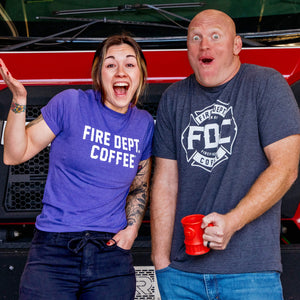 Three Fire Department Coffee Mystery T-Shirts in red, gray, and green with a question mark on each shirt. Underneath the shirts in bold text reads, "Mystery Shirt Selected At Random".